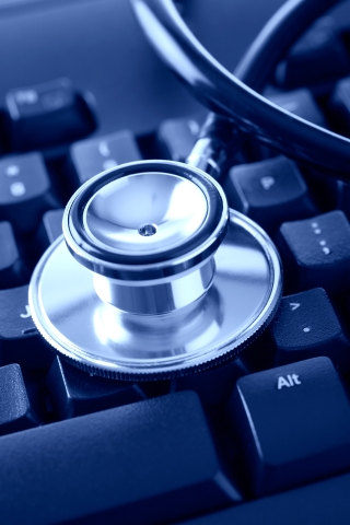 Stethoscope on a Computer Keyboard.  Blue toned.